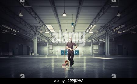 man with handtruck in warehouse Stock Photo
