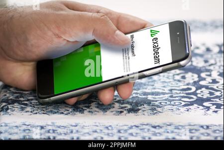 hand holding a phone with Exabeam mobile application on screen Stock Photo