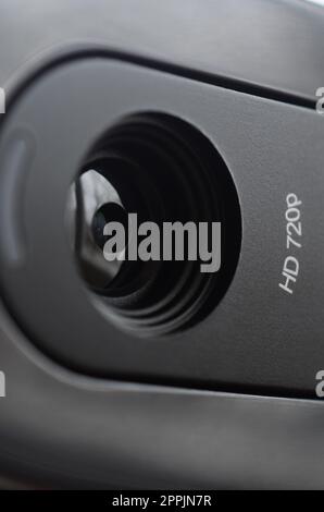 A modern web camera is installed on the body of a flat screen monitor ...