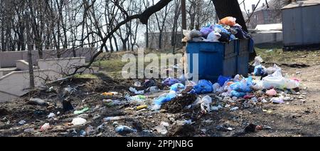 The garbage can is packed with garbage and waste. Untimely removal of garbage in populated areas Stock Photo