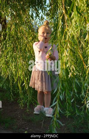 Little child under willow tree Stock Photo