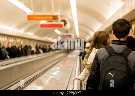 Budapest Hungary: People, commuters, riding the crowded and densely populated escalators of a subway or metro station in Budapest, making their way to the train tracks. Rush hour. Stock Photo