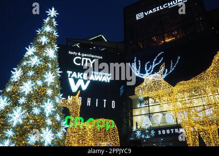 Moscow, Russia, January 17 2023 Street Christmas tree with snowflakes and festive balls. Metro Yugo-Zapadnaya. Christmas decorations in front of the mall. Silver stars, snowflakes and golden deers Stock Photo