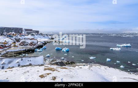 Nuuk old harbor panorama with blue icebergs drifting in the lagoon, Nuuk, Greenland Stock Photo