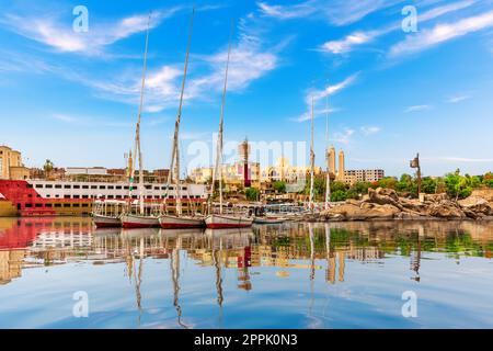 Sailboats in The Nile near the Coptic Orthodox Cathedral of the Archangel Michael, Aswan, Egypt Stock Photo
