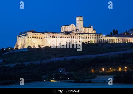 Assisi Basilica by night,  Umbria region, Italy. The town is famous for the most important Italian Basilica dedicated to St. Francis - San Francesco. Stock Photo