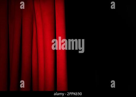 Open elegant red front curtains on black background. Space for text Stock Photo