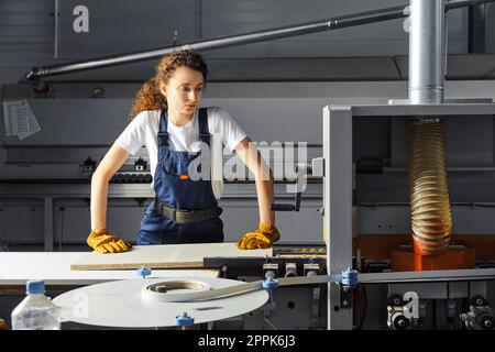 Female carpenter working in workshop Stock Photo