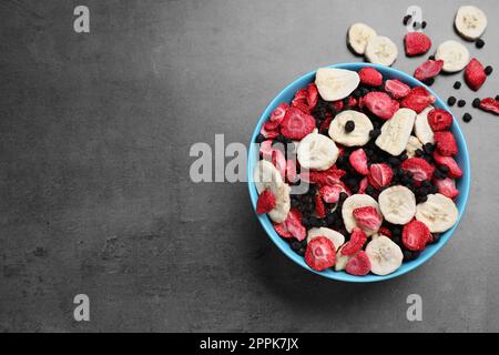 Bowl of dried fruits on grey table, top view. Space for text Stock Photo