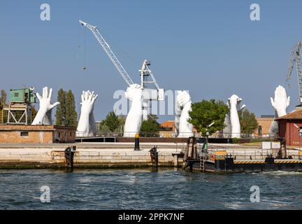 Giant joined hands sculpture Building Bridges by Lorenzo Quinn. Exhibition at Arsenale, Castello, Venice Stock Photo