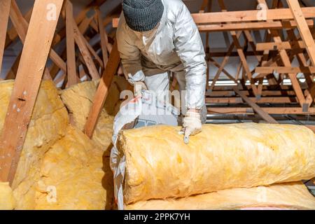 insulation of the house under the roof with the help of glass wool Stock Photo