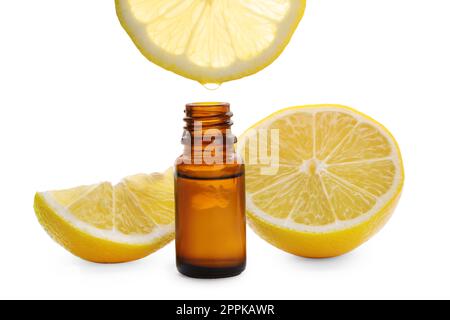 Dripping lemon essential oil from into bottle isolated on white Stock Photo