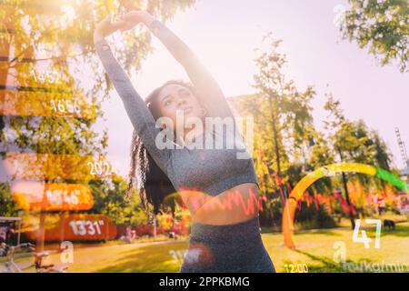 Woman does gym stretching exercises outdoor in a sunny day Stock Photo