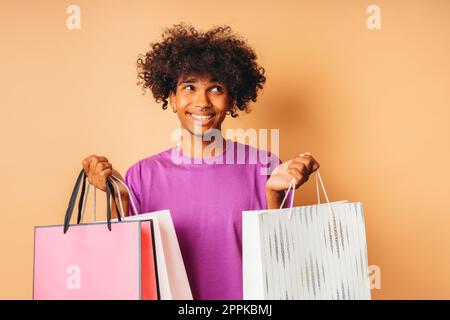 Happy smiling man with shopping bags in hand Stock Photo