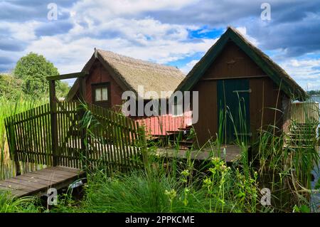 Fishing lodge on the lake near Krakow on the lake. Inland fishing. Vine roof on the house Stock Photo