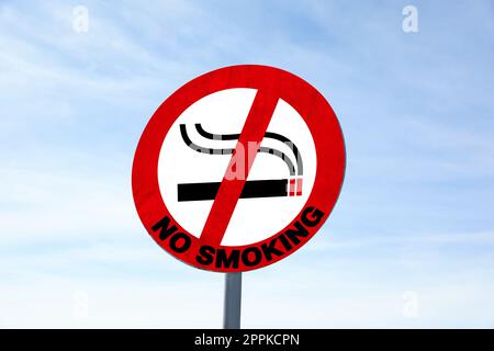 Sign No Smoking outdoors against blue sky Stock Photo