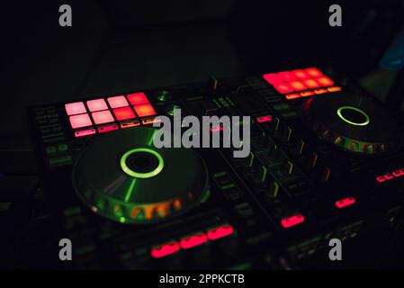 Dj mixes the track in the nightclub at a party Stock Photo