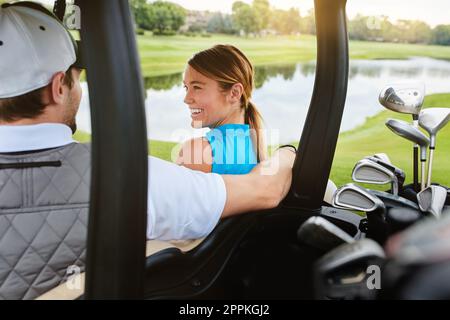 The best way to spend a day. an affectionate young couple spending a day on the golf course. Stock Photo