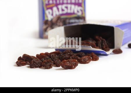Pile of Raisins With Box Isolated on White Background Stock Photo