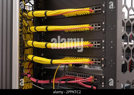 Tidy patched network cables, RJ45, connected to the switches and routers, data centre Stock Photo