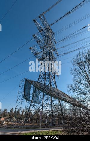 A newly installed high-voltage pylon with some cables connected Stock Photo