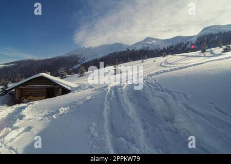 Snow covered log cabin on hill landscape photo Stock Photo