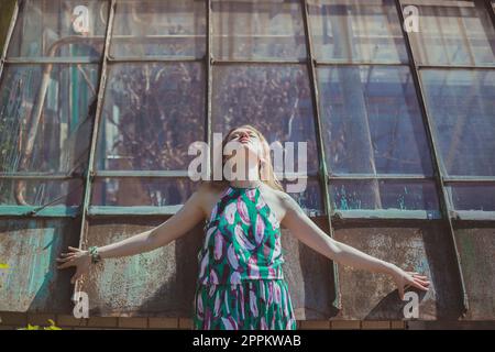 Young woman with closed eyes posing against tall windows scenic photography Stock Photo