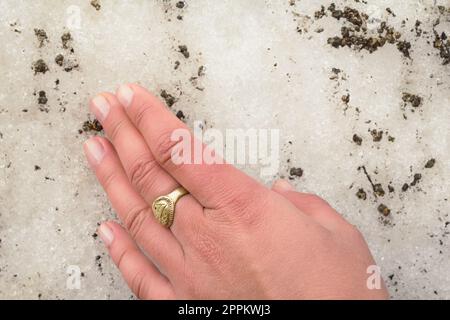 Close up woman touching dirty snow concept photo Stock Photo