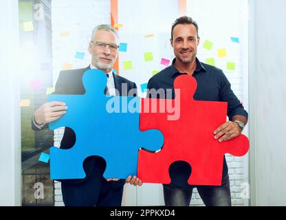 Partnership of business people. Concept of integration and startup with colored puzzle pieces Stock Photo