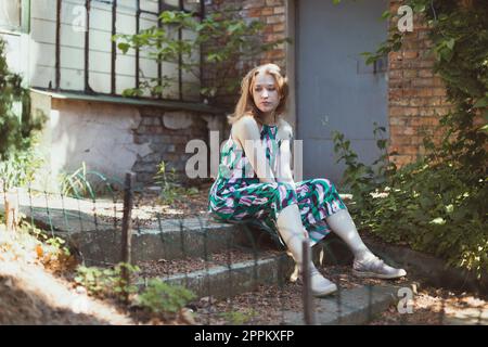 Woman looking away and sitting on doorstep scenic photography Stock Photo