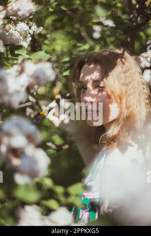 Close up sunlight shining through leaves on woman face portrait picture Stock Photo