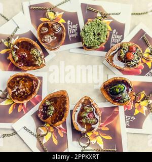 Close up pendants made of walnuts with floral details photo Stock Photo