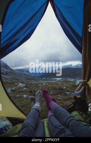 Close up friends in camp at mountain valley concept photo Stock Photo