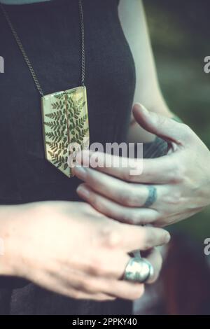Close up lady with stylish wooden pendant concept photo Stock Photo