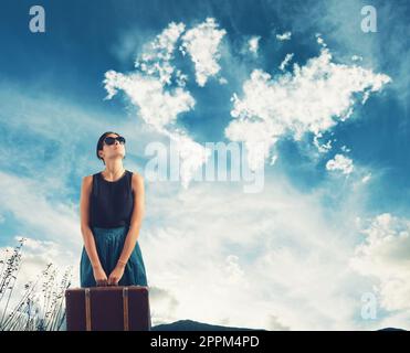 Girl with suitcase in her hand imagines traveling around the world Stock Photo