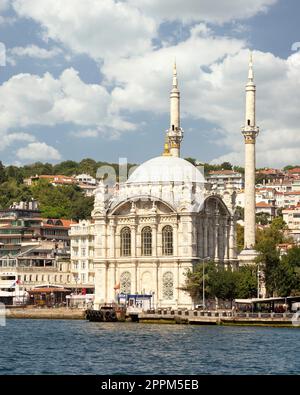 View from Bosphorus Strait overlooking Ortakoy Mosque, or Ortakoy Camii, suited at Ortakoy pier square, Istanbul, Turkey Stock Photo