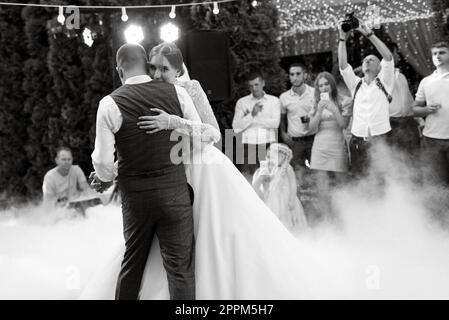 the first wedding dance of the bride and groom on a green meadow Stock Photo