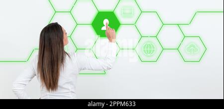Businesswoman in white office sirt standing and pressing virtual button with her finger. Women presenting new technologies for future. Futuristic digital design. Stock Photo