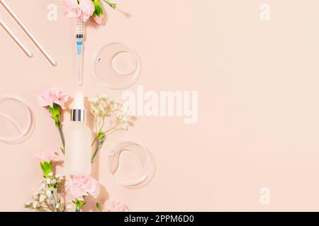 Concept of botox beauty injections. Syringe with toxin dropper bottle with serum and flowers on pink background. Cosmetic procedures for the face. Ski Stock Photo