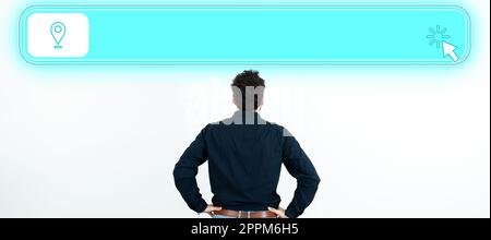 Businessman in black office shirt stands with his back in front white wall. Futuristic digital design presents new technologies of the future. Colored glow. Stock Photo