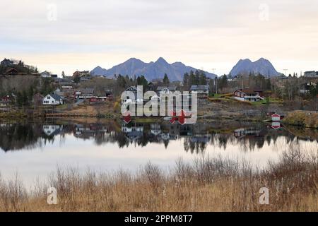 Reflection of a small village in a lake near Svolvaer in Norway Stock Photo