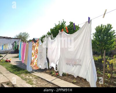 Sremska Mitrovica, Serbia July 10, 2020, towels and clothes dry on a rope. Housewife worries. The wet cloth is hung on clothespins for further drying. big washing Stock Photo