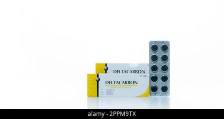 CHONBURI, THAILAND-JANUARY 30, 2023: Deltacarbon medicinal charcoal in blister pack and paper box package. Activated charcoal tablet pills. Black activated charcoal in blister pack isolated on white. Stock Photo