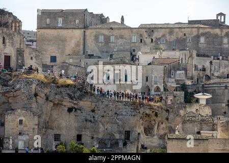 Tourists in the Sassi di Matera a historic district in the city of Matera. Stock Photo