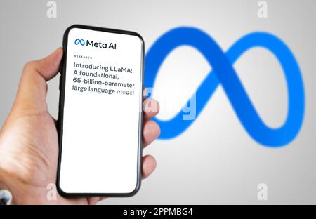 hand holding a phone with Meta AI LLaMa news on the screen Stock Photo