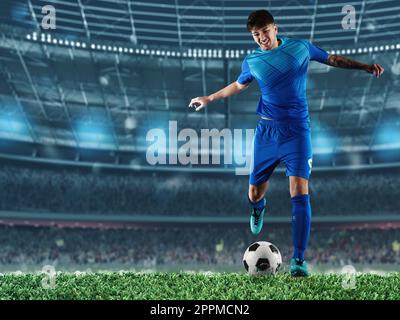 Player ready to kick the soccerball at the illuminated stadium during the match Stock Photo