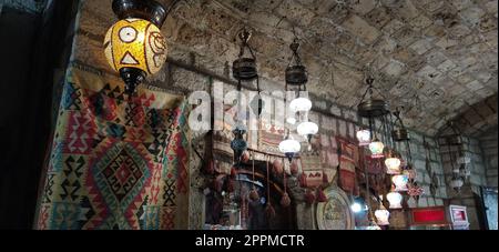 Traditional vintage Turkish lamps over light background in the night. Colored glass lamps and shades on the market in Sarajevo, Bosnia and Herzegovina. Sale of souvenirs in the market. Stock Photo