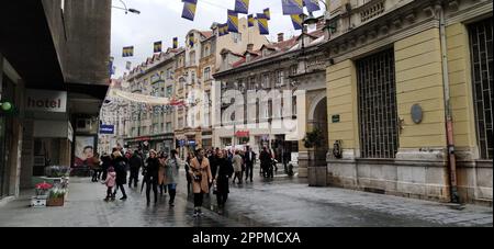 Sarajevo, Bosnia and Herzegovina, March 8, 2020. People on the streets of Sarajevo. Tourists and locals walk around the city center, visit shops, cafes. Historic Center of Sarajevo with Attractions Stock Photo