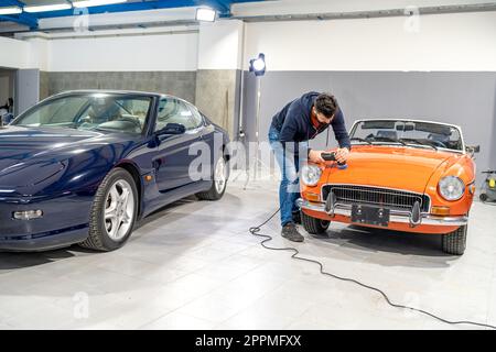 detailing, wash and cleaning of old and new cars in a car studio Stock Photo