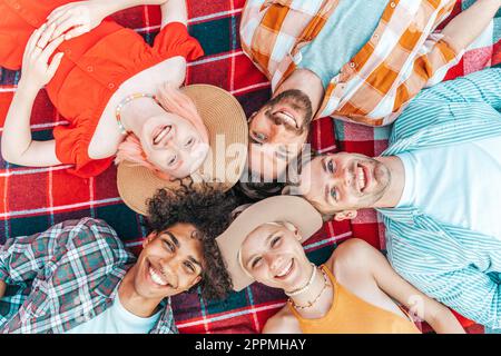 Group of friend relax together lying down in summer Stock Photo